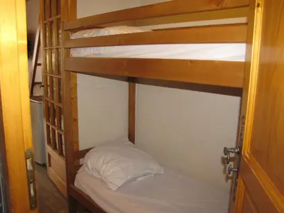 a couple of bunk beds in a room at Appartement à Chamonix avec Balcon, Animaux Acceptés et Parking - FR-1-517-12 in Chamonix-Mont-Blanc