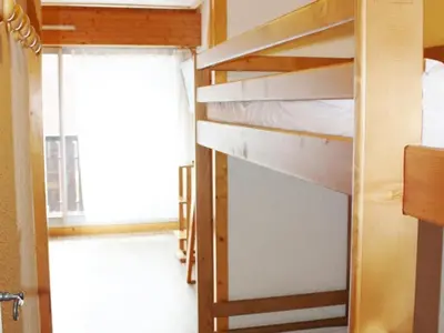 a bunk bed in a room with a window at Appartement à Chamonix avec Balcon, Animaux Acceptés et Parking - FR-1-517-12 in Chamonix-Mont-Blanc