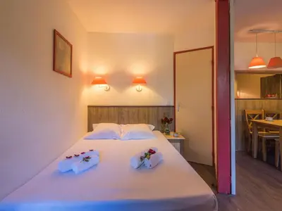 a bedroom with a white bed with flowers on it at Appartement Chamonix avec accès aux domaines skiables et parking - FR-1-517-13 in Chamonix-Mont-Blanc