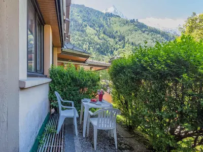 a dining room with a table with flowers on it at Appartement Chamonix avec accès aux domaines skiables et parking - FR-1-517-13 in Chamonix-Mont-Blanc