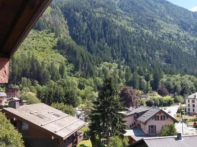 an aerial view of a mountain with a town and trees at Beau 3 pièces spacieux avec parking proche du Mont Blanc - 6 pers. - FR-1-517-15 in Chamonix-Mont-Blanc