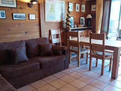 a living room with a couch and a table and chairs at Beau 3 pièces spacieux avec parking proche du Mont Blanc - 6 pers. - FR-1-517-15 in Chamonix-Mont-Blanc