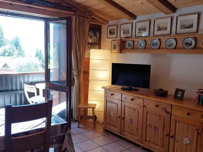 a living room with a television on a wooden cabinet at Beau 3 pièces spacieux avec parking proche du Mont Blanc - 6 pers. - FR-1-517-15 in Chamonix-Mont-Blanc