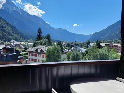 a balcony with a view of a city and mountains at Beau 3 pièces spacieux avec parking proche du Mont Blanc - 6 pers. - FR-1-517-15 in Chamonix-Mont-Blanc