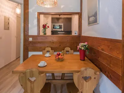 a dining room with a wooden table and chairs at Charmant 2 Pièces Chamonix, 4 Pers, Animaux Ok, Parking - FR-1-517-18 in Chamonix-Mont-Blanc