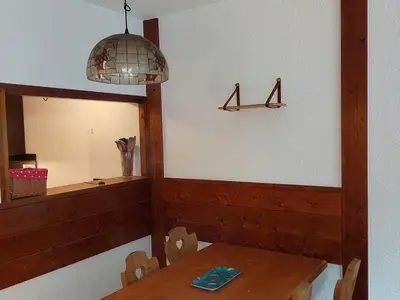 a dining room with a table and a mirror at Charmant 2 Pièces Chamonix, 4 Pers, Animaux Ok, Parking - FR-1-517-18 in Chamonix-Mont-Blanc