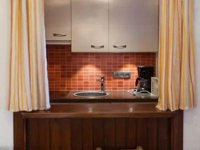 a kitchen with a sink and a counter top at 2 Pièces Vue Mont Blanc avec Balcon - Chamonix, Animaux acceptés - FR-1-517-19 in Chamonix-Mont-Blanc