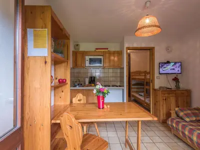 a kitchen with a wooden table in a room at Studio cosy à Chamonix - Animaux admis, parking privé - FR-1-517-21 in Chamonix-Mont-Blanc