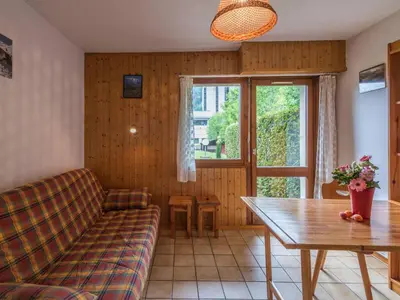 a living room with a couch and a table at Studio cosy à Chamonix - Animaux admis, parking privé - FR-1-517-21 in Chamonix-Mont-Blanc