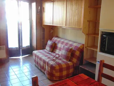 a living room with a couch in a room at Studio convivial en zone piétonne avec animaux admis, balcon - Chamonix - FR-1-517-23 in Chamonix-Mont-Blanc