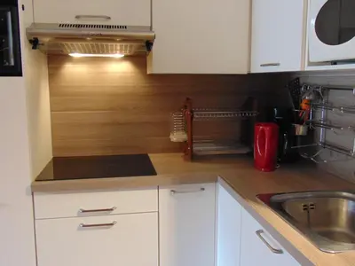a kitchen with white cabinets and a sink at Studio convivial en zone piétonne avec animaux admis, balcon - Chamonix - FR-1-517-23 in Chamonix-Mont-Blanc
