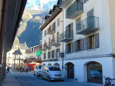 a street with cars parked next to a building at Studio convivial en zone piétonne avec animaux admis, balcon - Chamonix - FR-1-517-23 in Chamonix-Mont-Blanc