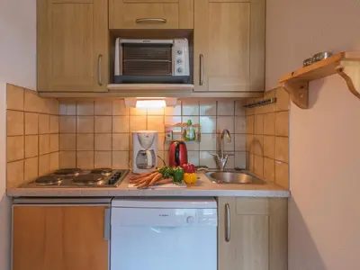 a small kitchen with a sink and a microwave at 2 Pièces à Chamonix, Vue Mont-Blanc, Animaux admis, Parking - FR-1-517-26 in Chamonix-Mont-Blanc
