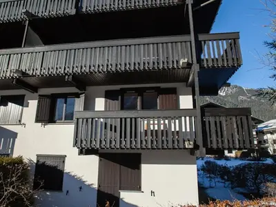 a building with wooden balconies on the side of it at Studio Charmant avec Vue Mont Blanc, Parking et Animaux Admis - FR-1-517-35 in Chamonix-Mont-Blanc