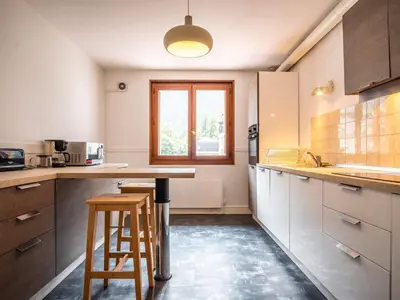 a living room with a couch and a dining room at Magnifique appartement centre-ville - Animaux admis, WiFi - FR-1-517-37 in Chamonix-Mont-Blanc