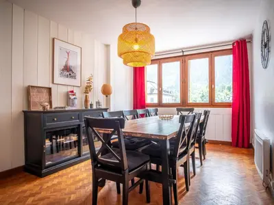 a living room with a couch with colorful pillows at Magnifique appartement centre-ville - Animaux admis, WiFi - FR-1-517-37 in Chamonix-Mont-Blanc