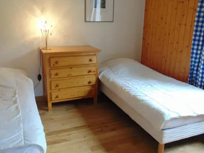 a bedroom with two beds and a wooden dresser at Charmant 3 pièces avec terrasse, parking, 6 couchages - Chamonix - FR-1-517-38 in Chamonix-Mont-Blanc
