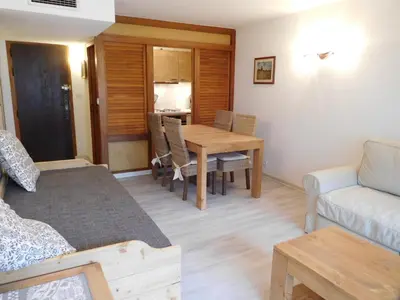 a living room with a table and a couch at Appartement 2 pièces Chamonix avec Parking - FR-1-517-39 in Chamonix-Mont-Blanc