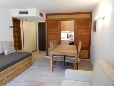 a bedroom with a bed and a dining room table at Appartement 2 pièces Chamonix avec Parking - FR-1-517-39 in Chamonix-Mont-Blanc
