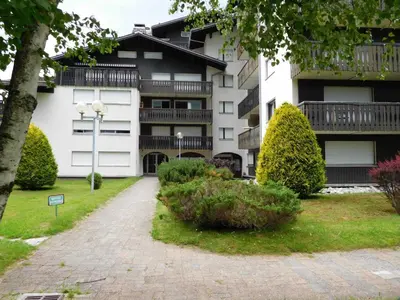 an apartment building with a walkway in front of it at Appartement 2 pièces Chamonix avec Parking - FR-1-517-39 in Chamonix-Mont-Blanc