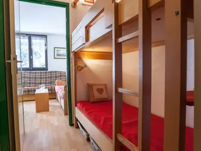 a small room with a bunk bed and a couch at Studio Chamonix 20m², 4 pers, balcon, parking - FR-1-517-40 in Chamonix-Mont-Blanc
