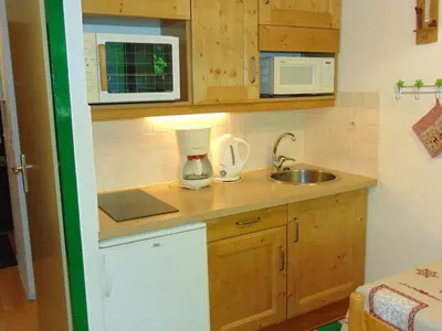 a small kitchen with a sink and a microwave at Studio Chamonix 20m², 4 pers, balcon, parking - FR-1-517-40 in Chamonix-Mont-Blanc