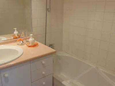 a bathroom with a sink and a bath tub at Charmant 2 Pièces Central avec Terrasse - Chamonix - FR-1-517-41 in Chamonix-Mont-Blanc