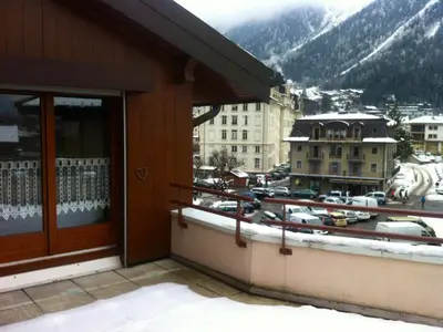 a balcony of a building with a view of a city at Charmant 2 Pièces Central avec Terrasse - Chamonix - FR-1-517-41 in Chamonix-Mont-Blanc