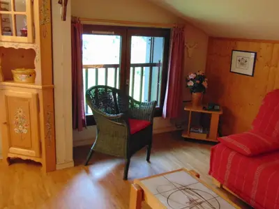 a living room with a couch and a chair at Bel appartement rénové à Chamonix avec vue sur le Mont-Blanc, parking et animaux admis - FR-1-517-51 in Chamonix-Mont-Blanc