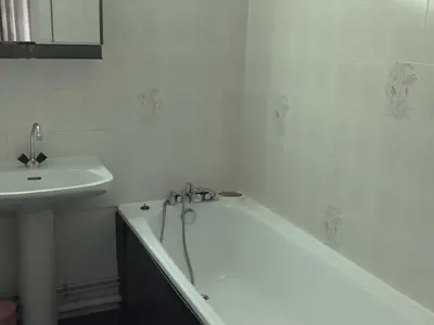 a white bathroom with a tub and a sink at Bel appartement rénové à Chamonix avec vue sur le Mont-Blanc, parking et animaux admis - FR-1-517-51 in Chamonix-Mont-Blanc
