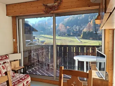 a large window in a room with a view of a mountain at Studio cosy proche des pistes - Animaux admis - FR-1-517-52 in Chamonix-Mont-Blanc