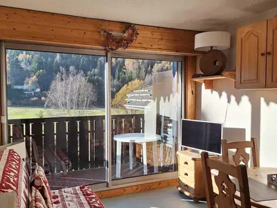 a living room with a large window with a view at Studio cosy proche des pistes - Animaux admis - FR-1-517-52 in Chamonix-Mont-Blanc