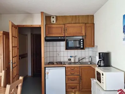 a kitchen with a white refrigerator and a microwave at Studio cosy proche des pistes - Animaux admis - FR-1-517-52 in Chamonix-Mont-Blanc