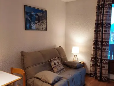 a living room with a couch and a table with a lamp at 2 Pièces Sud-Est Chamonix, Parking & Animaux admis - FR-1-517-54 in Chamonix-Mont-Blanc