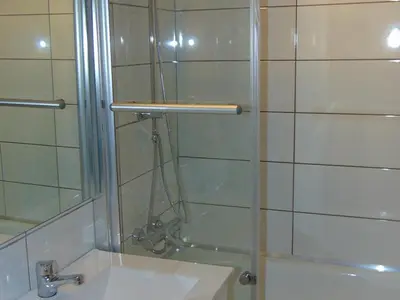 a shower with a glass door next to a sink at 2 Pièces Sud-Est Chamonix, Parking & Animaux admis - FR-1-517-54 in Chamonix-Mont-Blanc