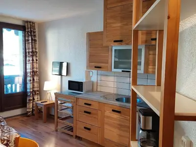 a room with a kitchen with a microwave and a counter at 2 Pièces Sud-Est Chamonix, Parking & Animaux admis - FR-1-517-54 in Chamonix-Mont-Blanc
