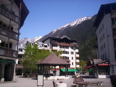 a town with a gazebo in front of a mountain at 2 Pièces Sud-Est Chamonix, Parking & Animaux admis - FR-1-517-54 in Chamonix-Mont-Blanc