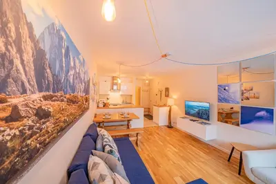 a living room with a couch and a tv at Apartment Arve - Chamonix Peaks Retreat in Chamonix-Mont-Blanc