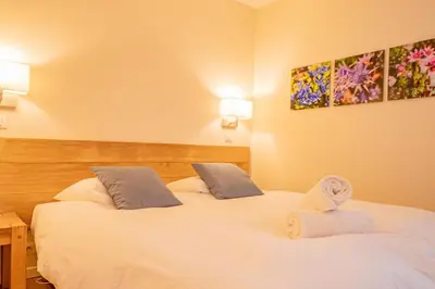 a bedroom with two beds with towels on them at Apartment Arve - Chamonix Peaks Retreat in Chamonix-Mont-Blanc