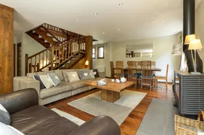 a living room with a couch and a table at Villa Loppe - Chamonix Mountain Four-Bedroom Hidden Gem in Chamonix-Mont-Blanc