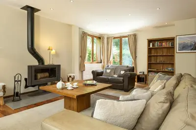a living room with a couch and a fireplace at Villa Loppe - Chamonix Mountain Four-Bedroom Hidden Gem in Chamonix-Mont-Blanc