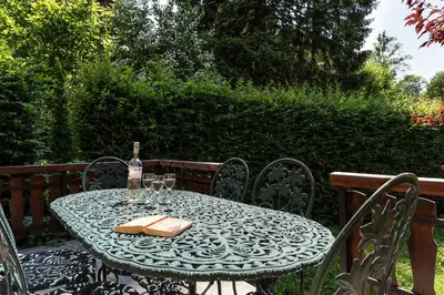 a table with a bottle of wine and two glasses at Villa Loppe - Chamonix Mountain Four-Bedroom Hidden Gem in Chamonix-Mont-Blanc