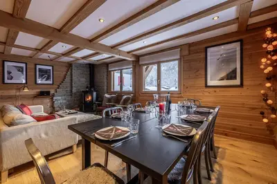 a dining room with a table and a couch at Chalet La Chaumière in Chamonix-Mont-Blanc