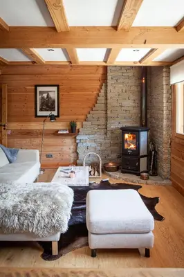 a living room with a couch and a fireplace at Chalet La Chaumière in Chamonix-Mont-Blanc