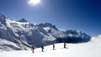 a group of people skiing down a snow covered mountain at Mazot Loppe - A Cosy Central Chamonix Hideaway in Chamonix-Mont-Blanc