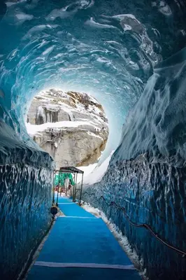 a blue carpeted tunnel in an ice cave at Mazot Loppe - A Cosy Central Chamonix Hideaway in Chamonix-Mont-Blanc
