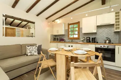 a kitchen and living room with a table and a couch at Mazot Loppe - A Cosy Central Chamonix Hideaway in Chamonix-Mont-Blanc