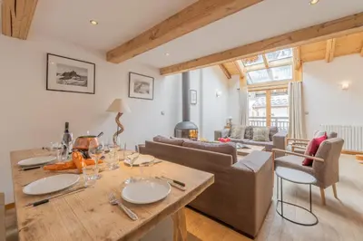 a kitchen and dining room with a wooden table and chairs at Appartement Clusettes - Happy Rentals in Chamonix-Mont-Blanc