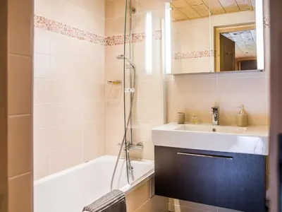 a bathroom with a sink and a shower at Les Chalets des Liarets in Chamonix-Mont-Blanc