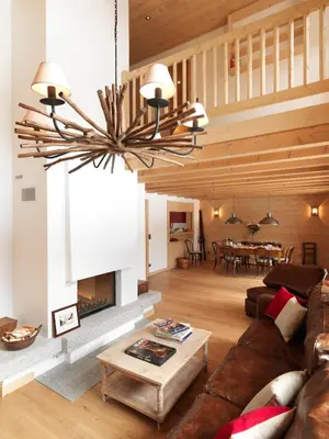a living room with a couch and a fireplace at Les Chalets des Liarets in Chamonix-Mont-Blanc